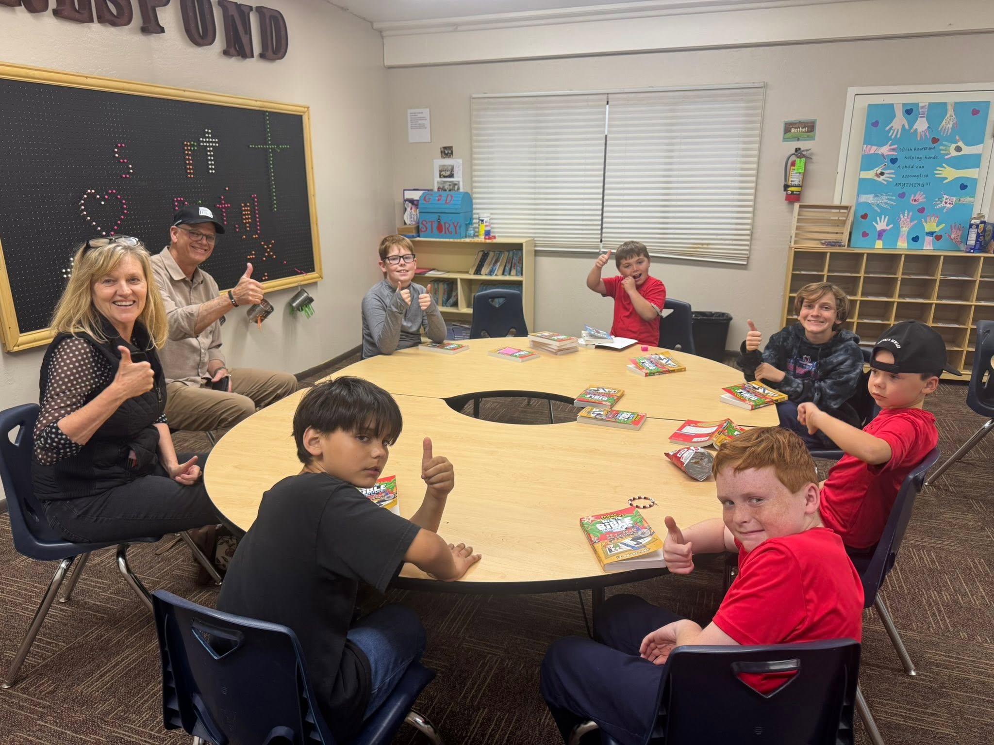 Boys Club reading together around a classroom table