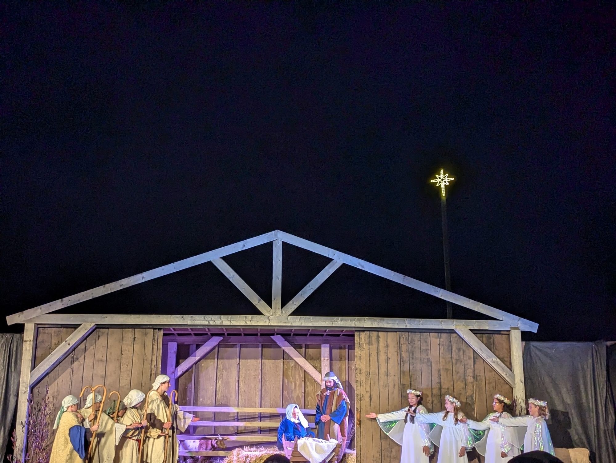 Shepherds, holy family, and angels at the Streets of Bethlehem manger under the star