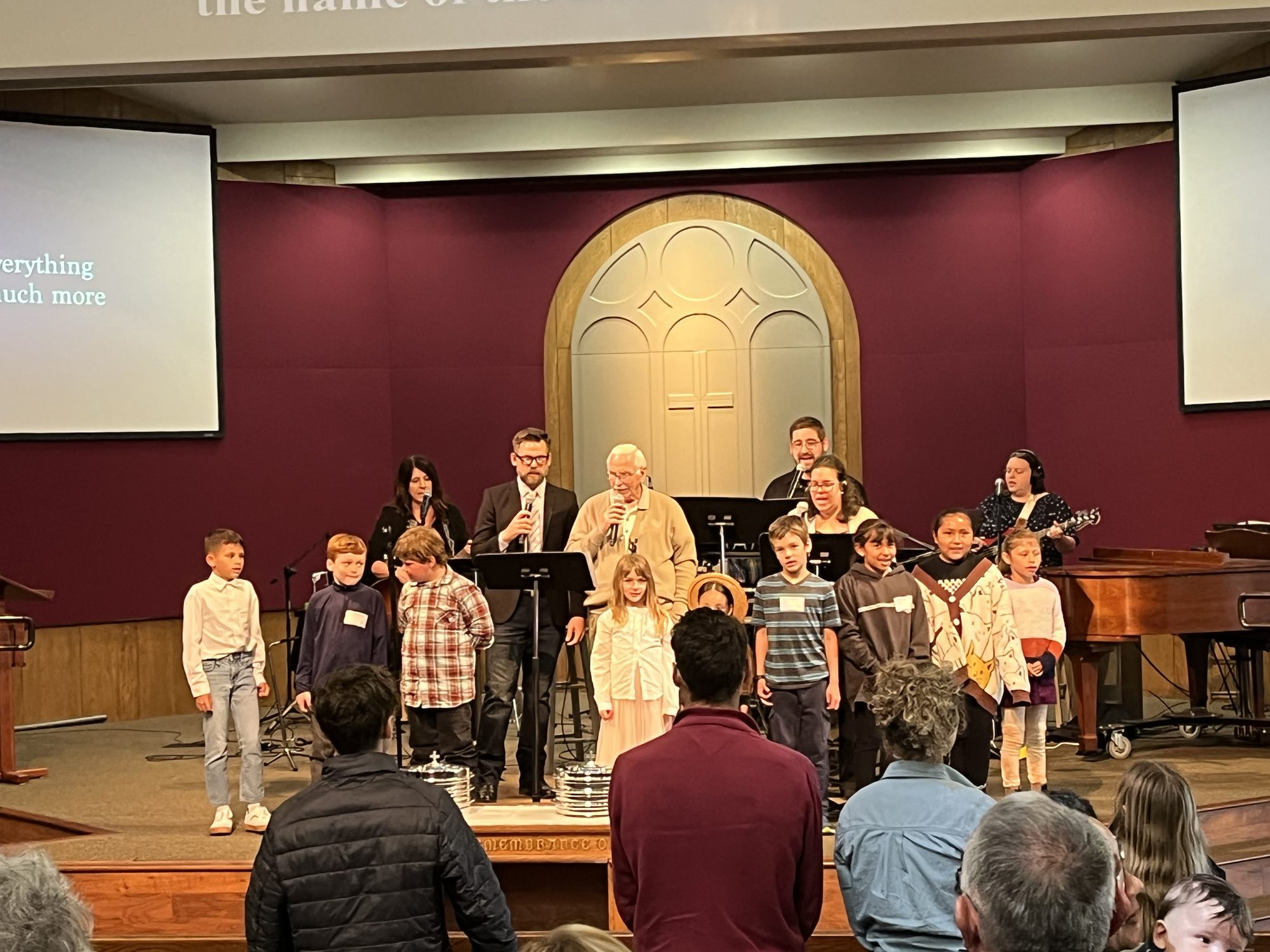 Children and worship leaders on stage during a Sunday service